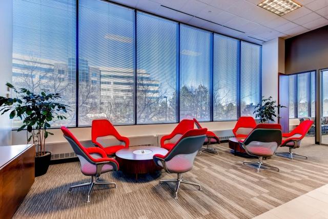Image of empty office space with tables and chairs